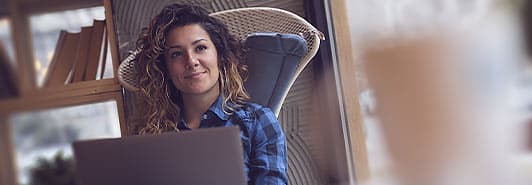 woman sitting in chair with laptop