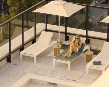 A woman is sitting on a sun lounger3 at Scout Living, powered by Placemakr, Atlanta