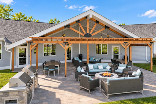A patio with a fire pit and seating area.
