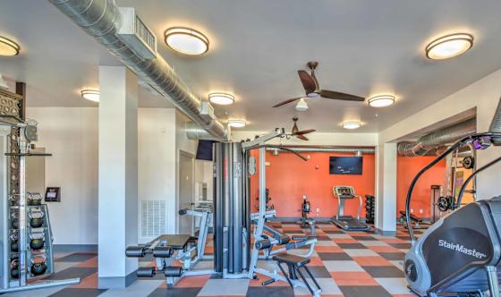 A gym with a variety of equipment including a StairMaster.
