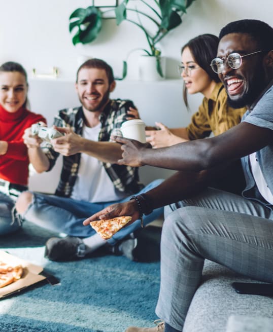 Friends enjoying pizza, coffee, and video games
