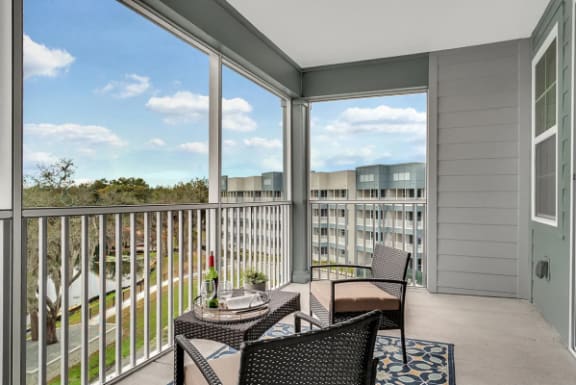a patio with chairs and tables on a balcony