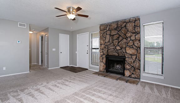 apartment with fireplace and ceiling fan at ponderosa apartments