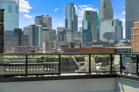 the view of the city from the rooftop deck of a building