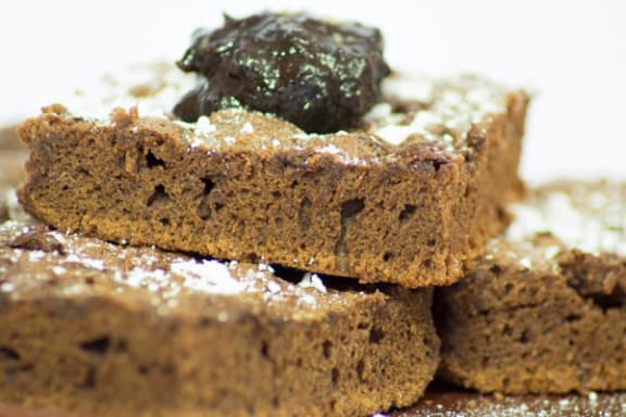 a close up of a piece of brown bread with a green filling