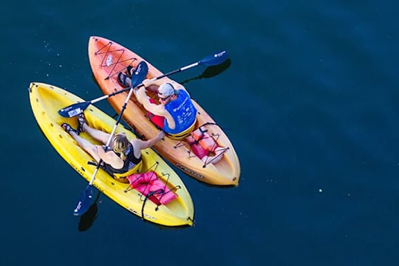 Two people kayaking in the water.