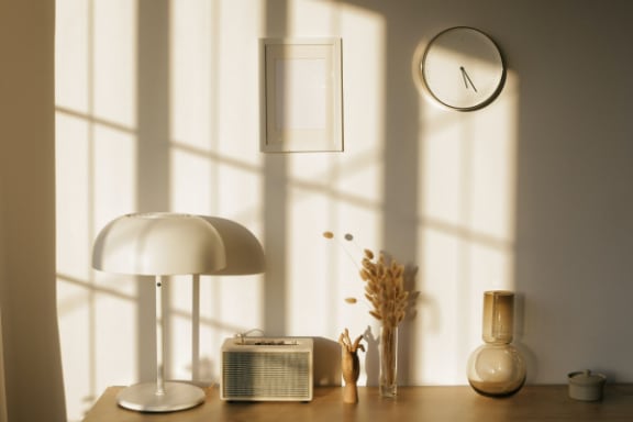 a desk with a lamp and a clock on it
