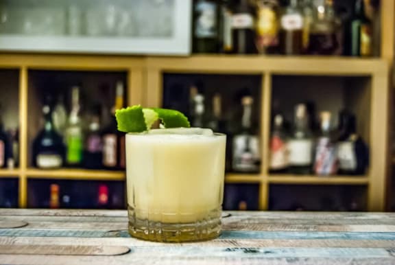 a cocktail in a glass on a bar