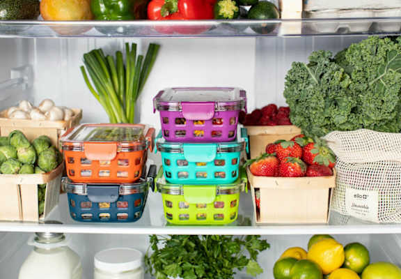 a refrigerator filled with different containers of fruit and vegetables