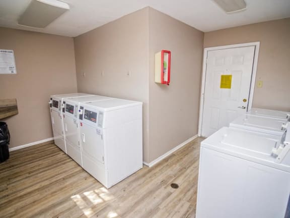 a room with two washing machines and a door