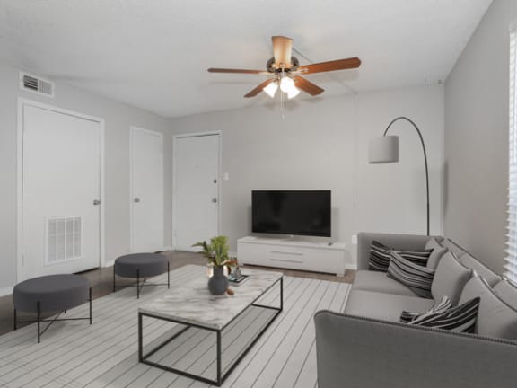 our apartments offer a living room with a couch and a tv