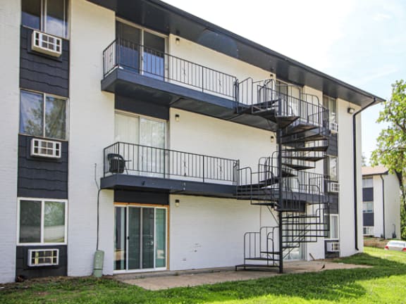 an exterior view of an apartment building with patio