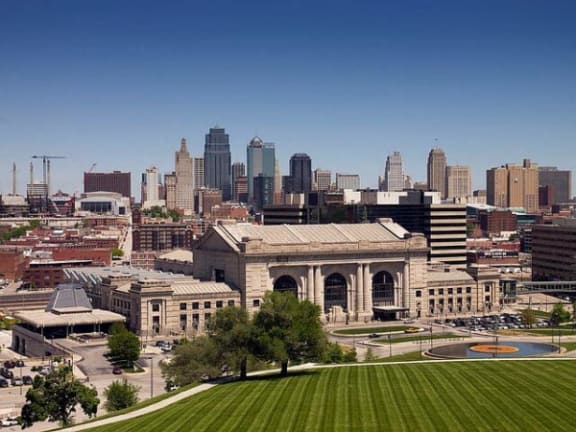 a cityscape of a city with a building and a field