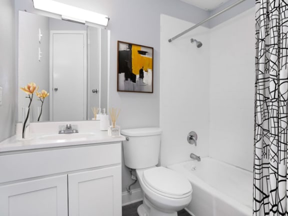 a bathroom with a tun and shower