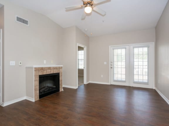 living room with a fireplace and a ceiling fan
