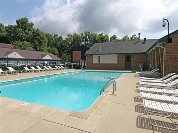 an aerial view of a pool and a patio with a picnic table