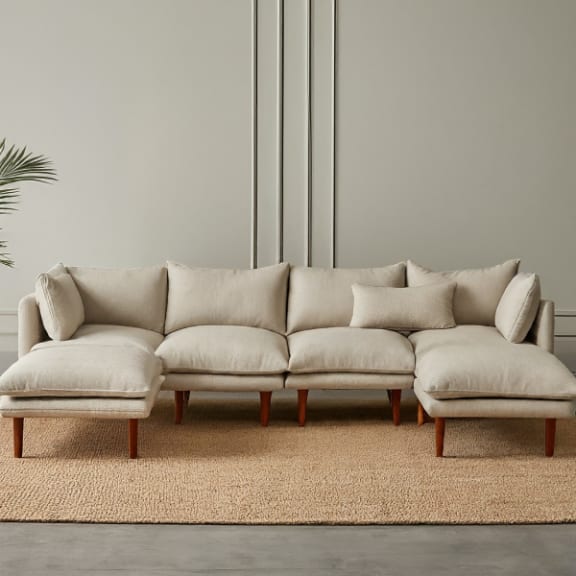a couch sitting on a rug in a living room