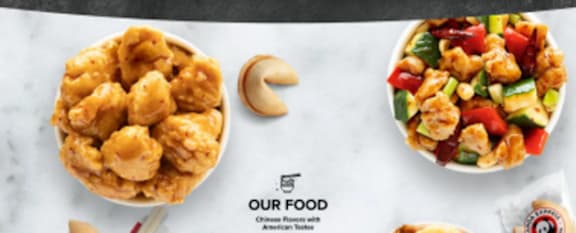 Two bowls of food with the text "OUR FOOD" on the table.