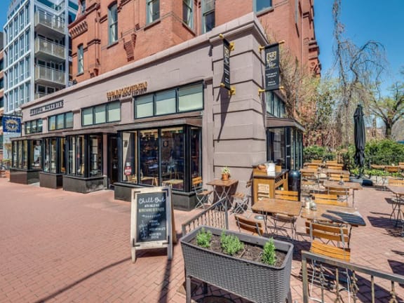 a patio with tables and chairs outside of a building