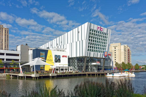 a large white building next to a body of water