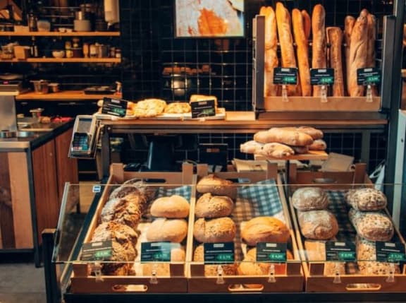 a display case filled with lots of different types of bread
