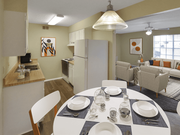 a dining room and living room with a white table and chairs