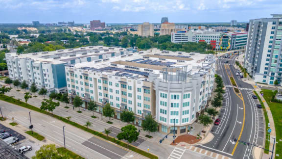 an aerial view of an office building with a city in the background