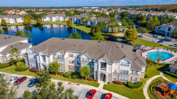an aerial view of an apartment complex with a lake