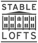 A black and white image of a building with the words "Stable Lofts" written above it.