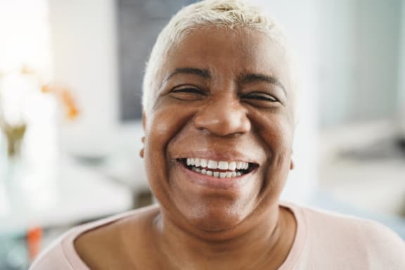 an older woman smiling with her eyes closed