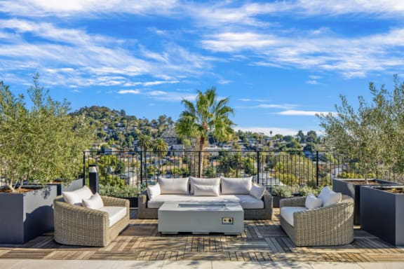 a roof deck with couches and a table