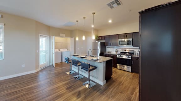 a kitchen with an island and a table with chairs
