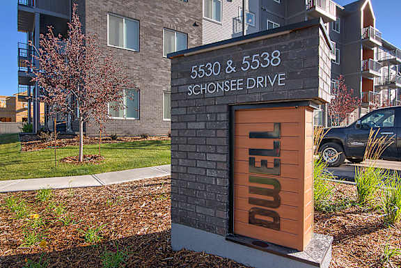 A sign for a building at 5530 & 5538 Schonsee Drive is shown.
