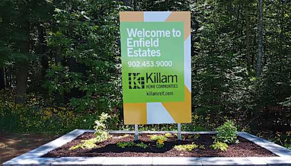 A sign welcoming people to Enfield Estates