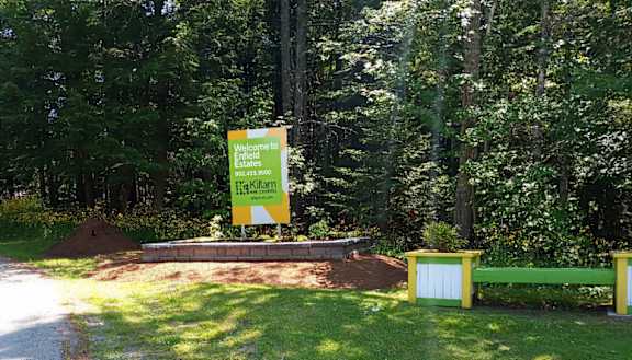 A sign welcoming visitors to Hilliard Estates is displayed in a grassy area.