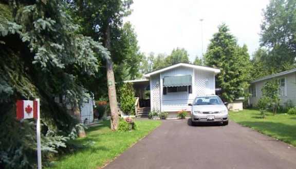 A house with a Canadian flag in front of it.