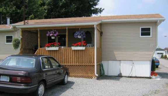 A car is parked in front of a garage.
