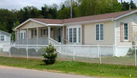 A house with a white fence in front of it.