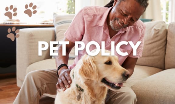 a man sitting on a couch with a dog