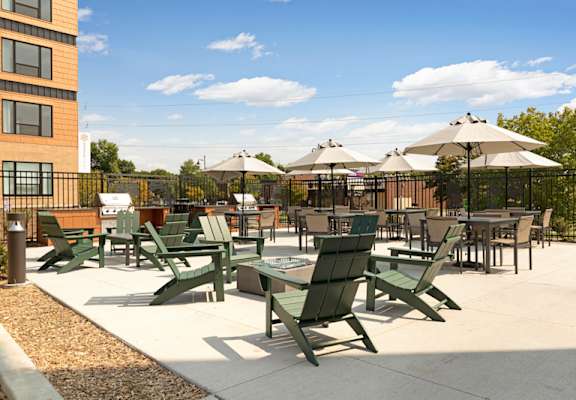 a patio with tables and chairs and umbrellas