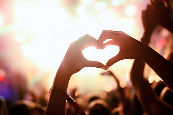 hands forming a heart shape at a concert at Carmel Vista, McDonough, Georgia