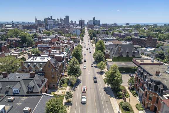 an aerial view of a city street with cars and buildings