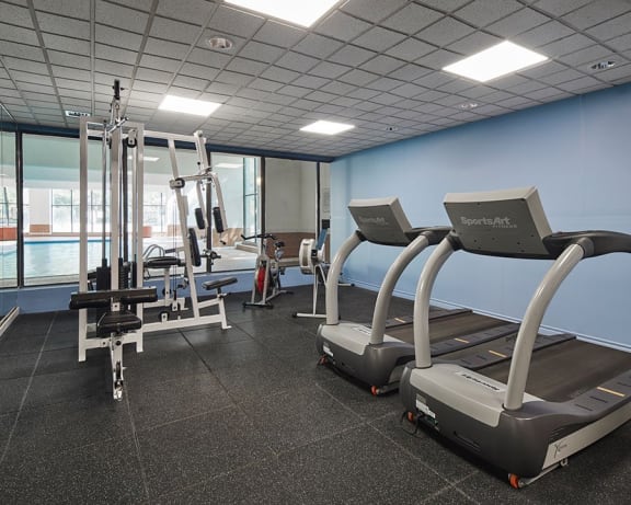 Gym with treadmills, elliptical, stationary bike and weight machines.