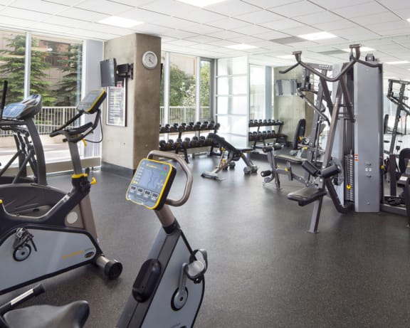 Fitness facility with weight bench, weights, elliptical, and bike