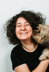 a woman with a dog on her shoulder at ReVive Apartments, Washington, 98424