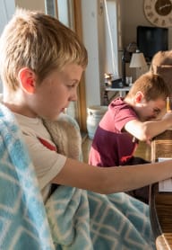 two young boys sitting at a table working on homework at Union Arms, Washington, 98122