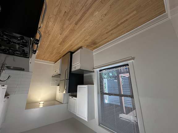 A kitchen with a black stove top oven and white cabinets.