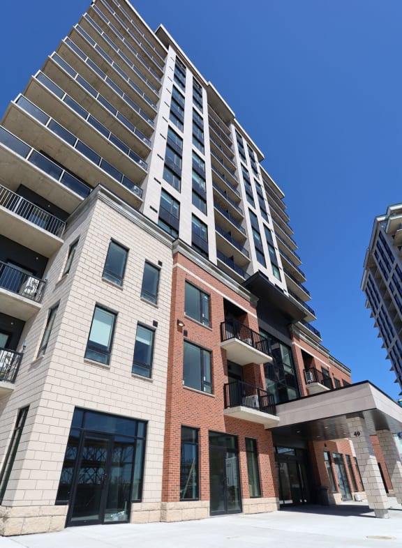 a view of a tall apartment building from below