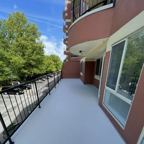 a view of the side of a building with windows and awnings at Carisbrooke at Manchester Apartments, New Hampshire, 03102