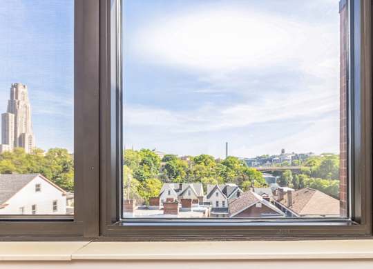 A view of a University of Pittsburgh and Carnegie Mellon University through a window.